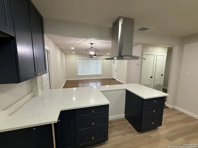 a kitchen with a sink window and refrigerator
