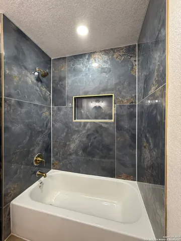 a bathroom with a tub and a shower