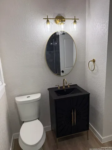 a bathroom with a toilet sink and mirror