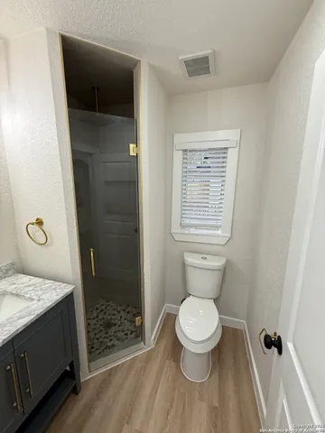 a bathroom with a toilet and a shower