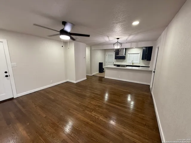 a large kitchen with kitchen island a stove a sink and a refrigerator
