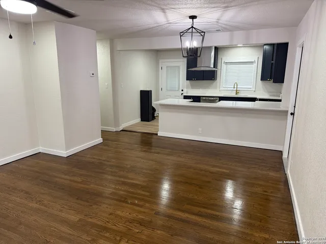 a view of kitchen with granite countertop cabinets and wooden floor