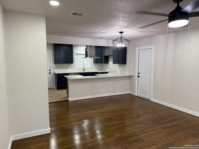 a view of kitchen with sink microwave and cabinets