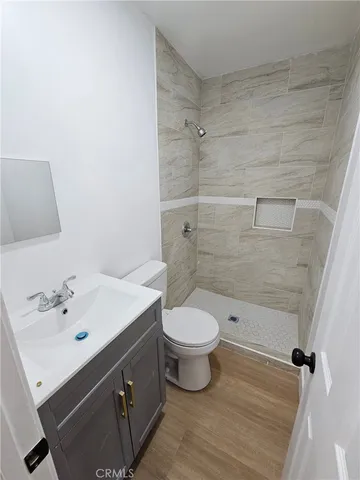 a bathroom with a sink mirror toilet and shower
