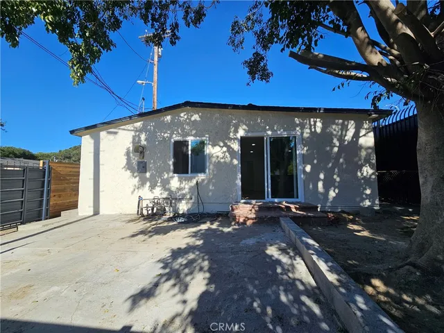 a view of a house with backyard porch and sitting area
