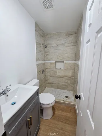 a bathroom with a sink toilet and shower
