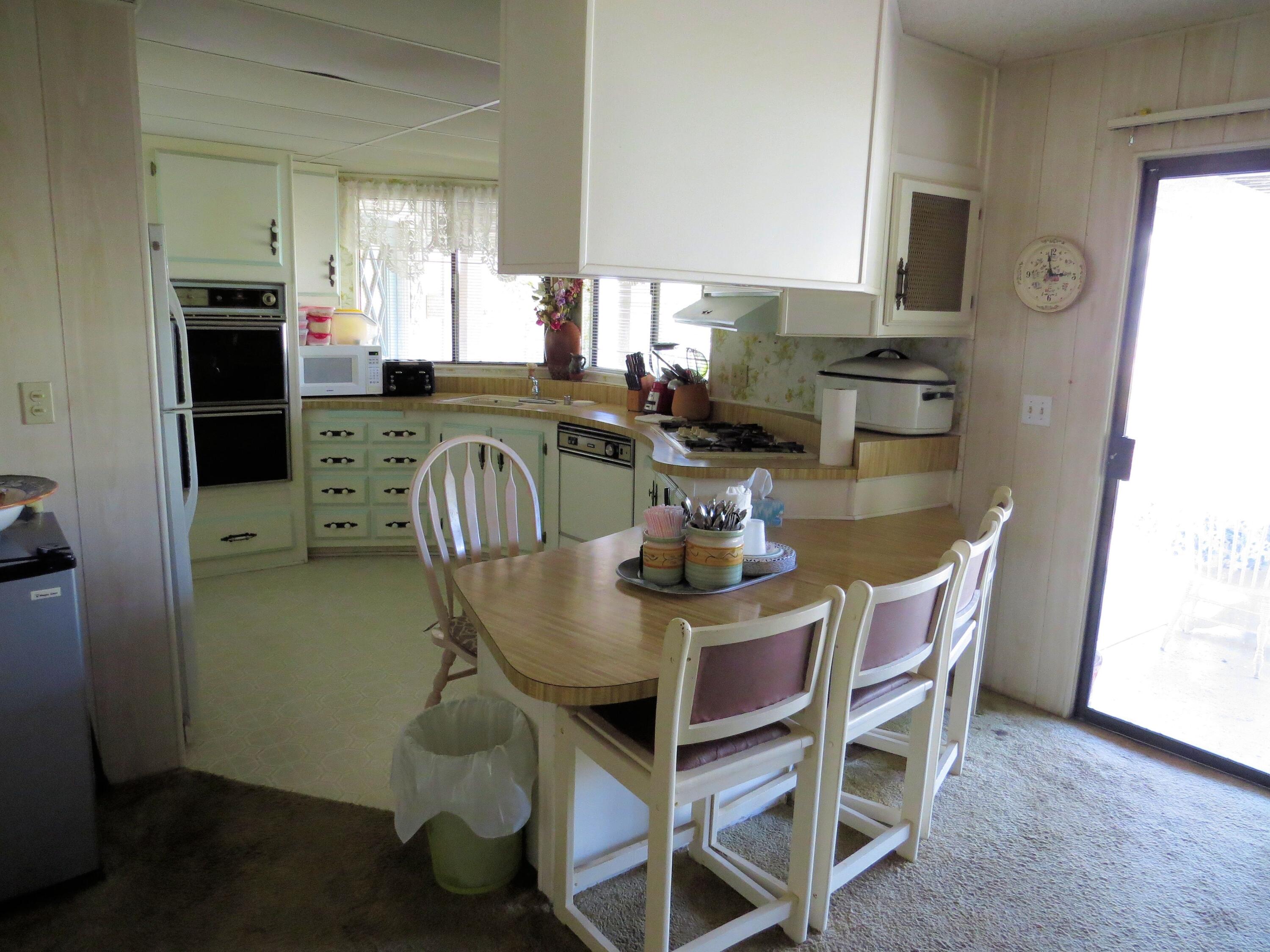 34980 Serenade Thousand Palms, CA 92276 - Photo 12 of 37 a dining room with furniture a window and kitchen view