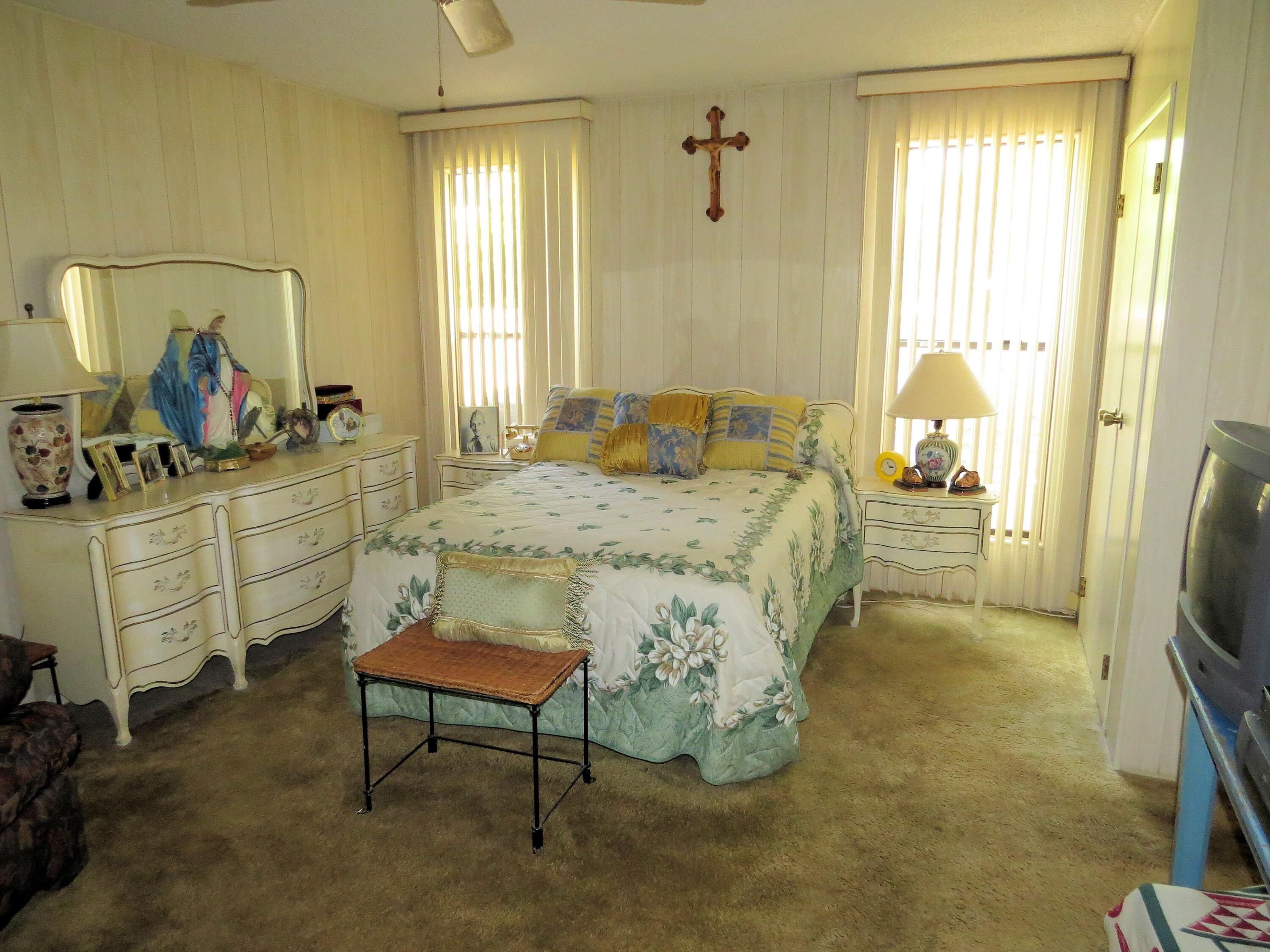 34980 Serenade Thousand Palms, CA 92276 - Photo 20 of 37 a bedroom with a bed and a dresser in it