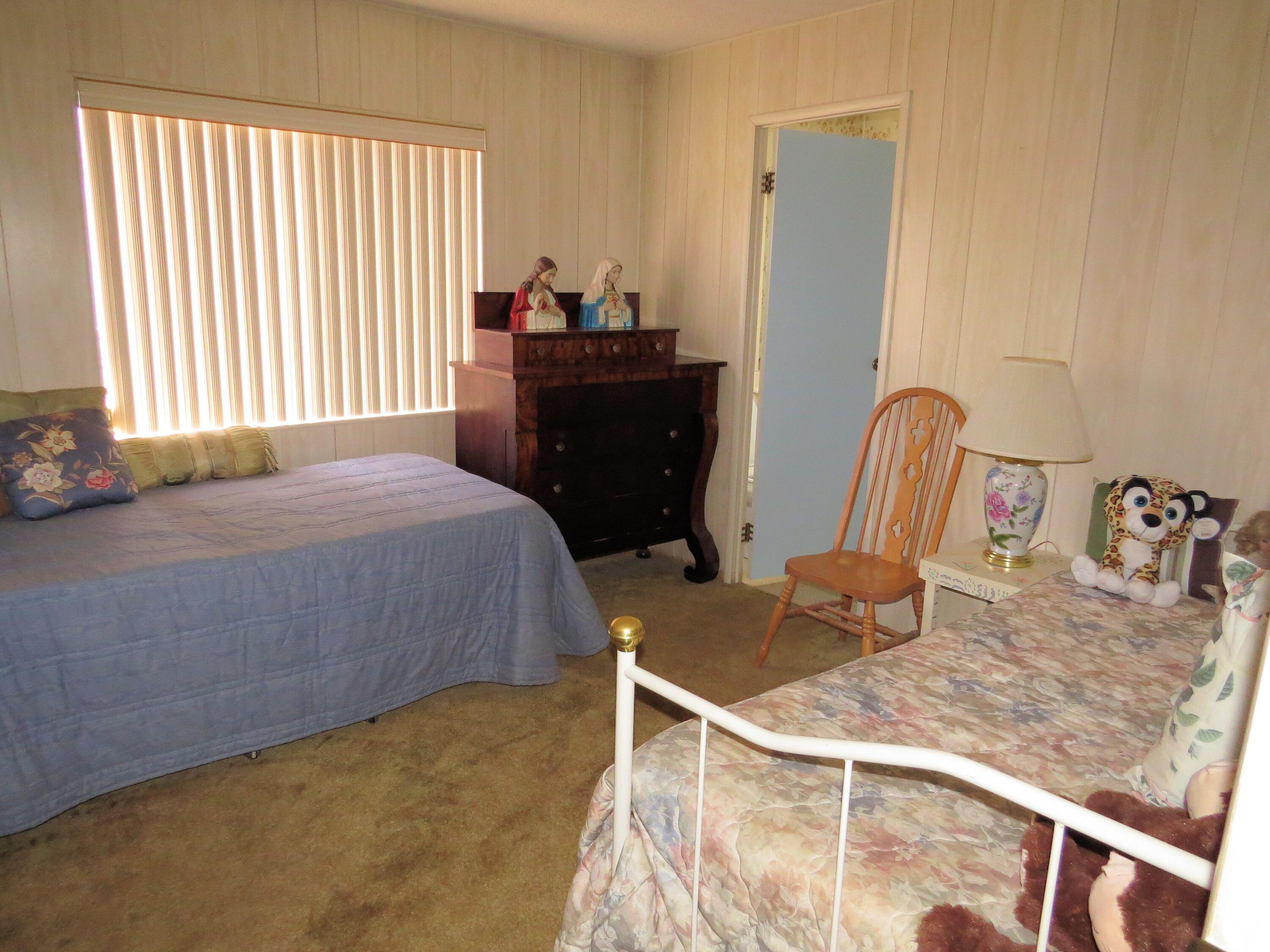 34980 Serenade Thousand Palms, CA 92276 - Photo 26 of 37 a bedroom with a bed and a table
