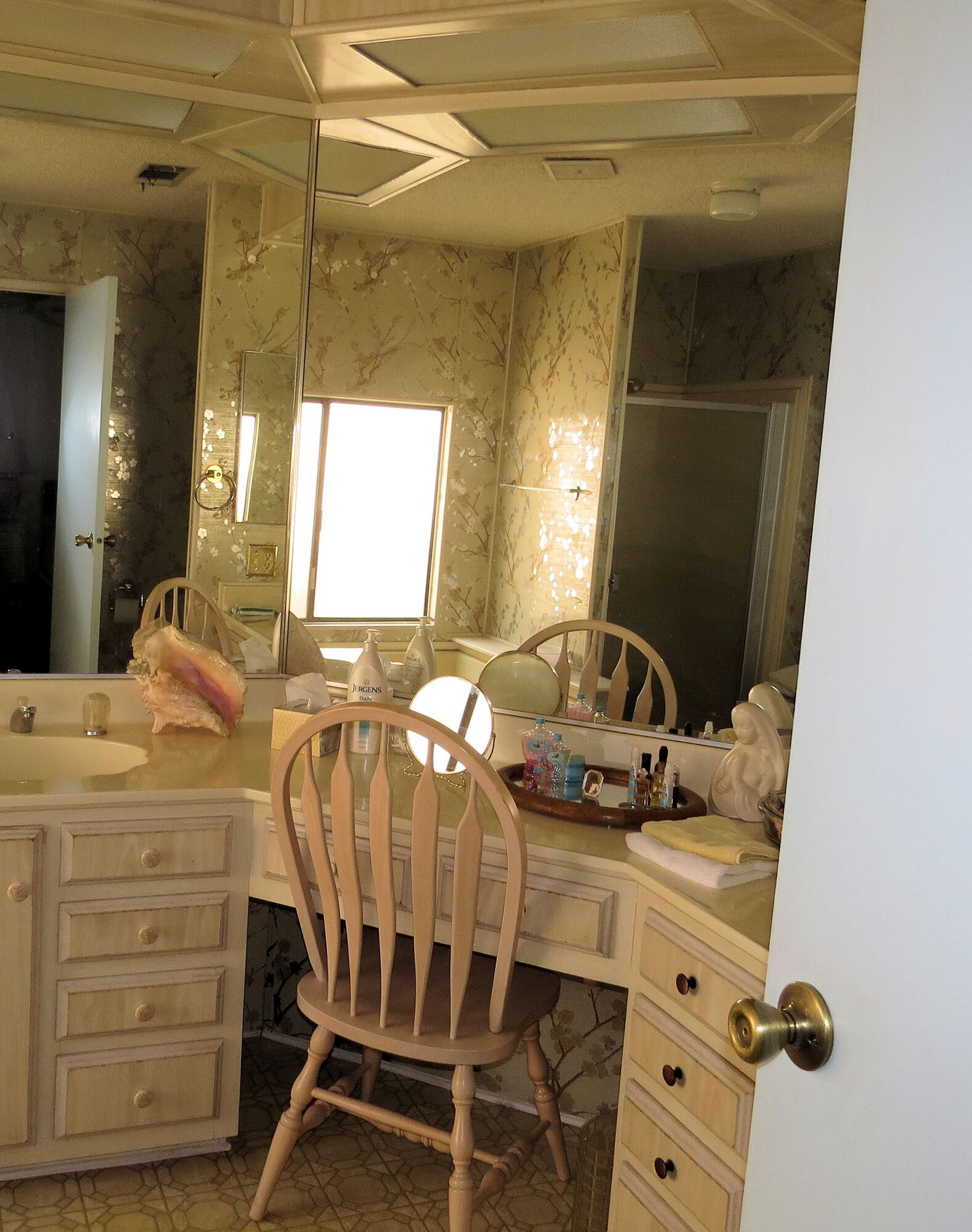 34980 Serenade Thousand Palms, CA 92276 - Photo 28 of 37 a bedroom with a bed and a mirror