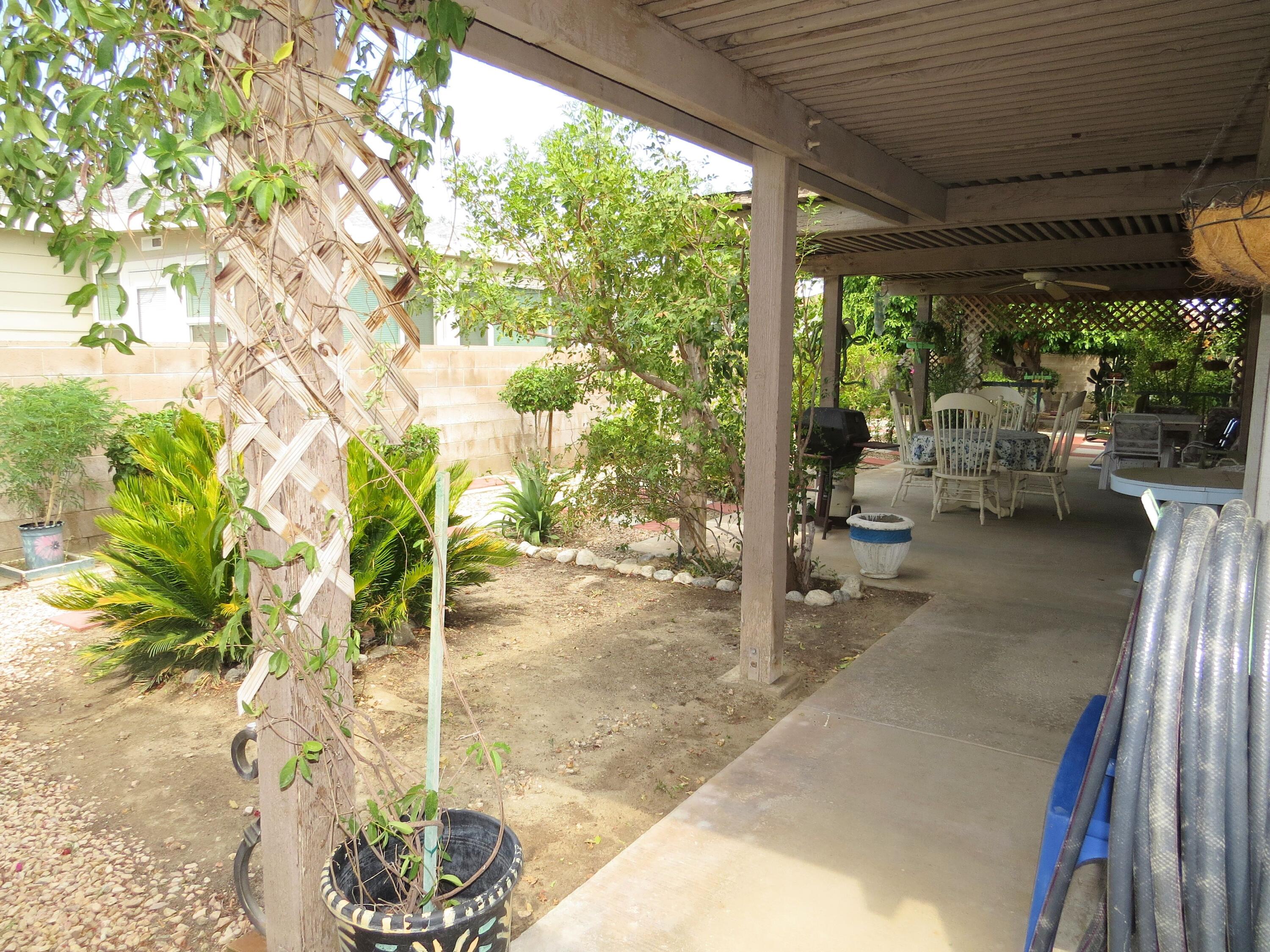 34980 Serenade Thousand Palms, CA 92276 - Photo 30 of 37 a living room with patio furniture and a potted plant