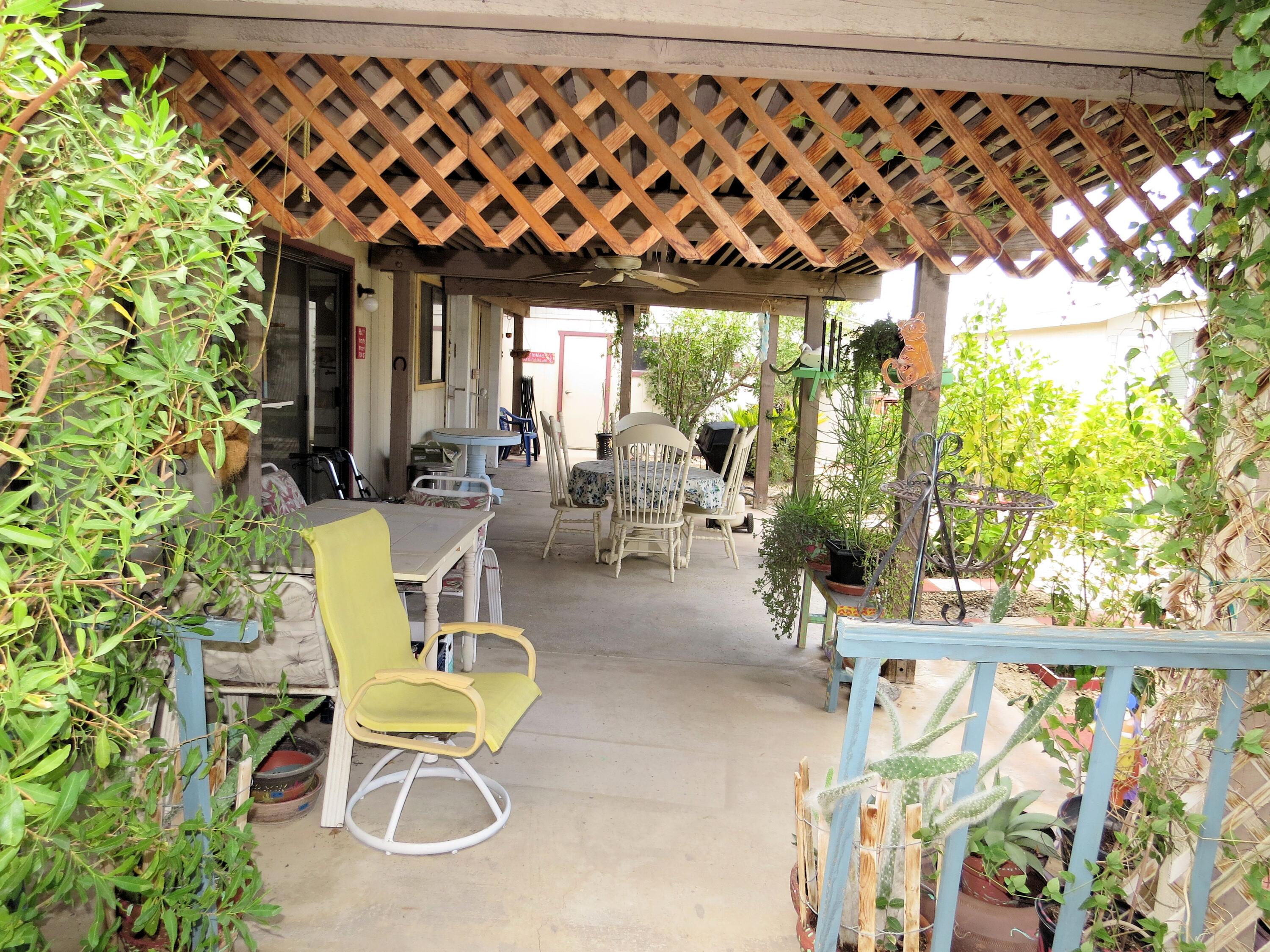 34980 Serenade Thousand Palms, CA 92276 - Photo 34 of 37 a view of a chairs and table in patio with wooden fence