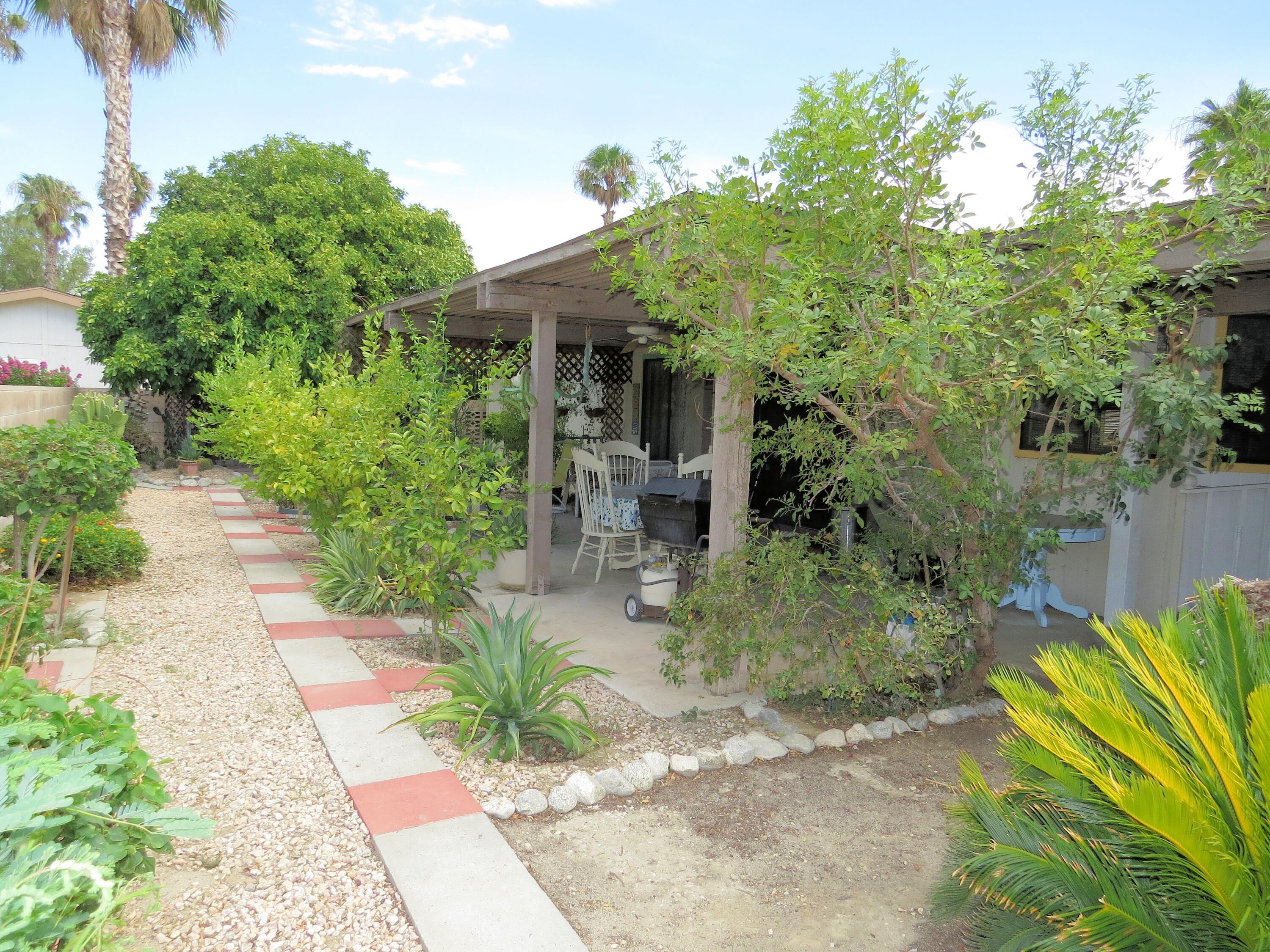 34980 Serenade Thousand Palms, CA 92276 - Photo 35 of 37 a front view of a house with a yard