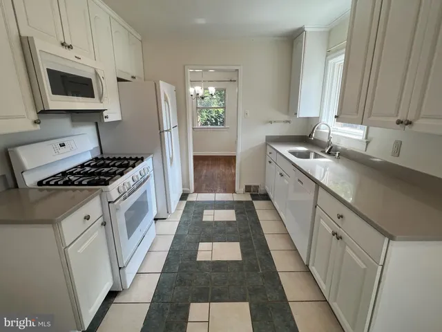 a kitchen with a sink stove and microwave
