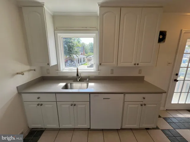 a kitchen with a sink cabinets and window