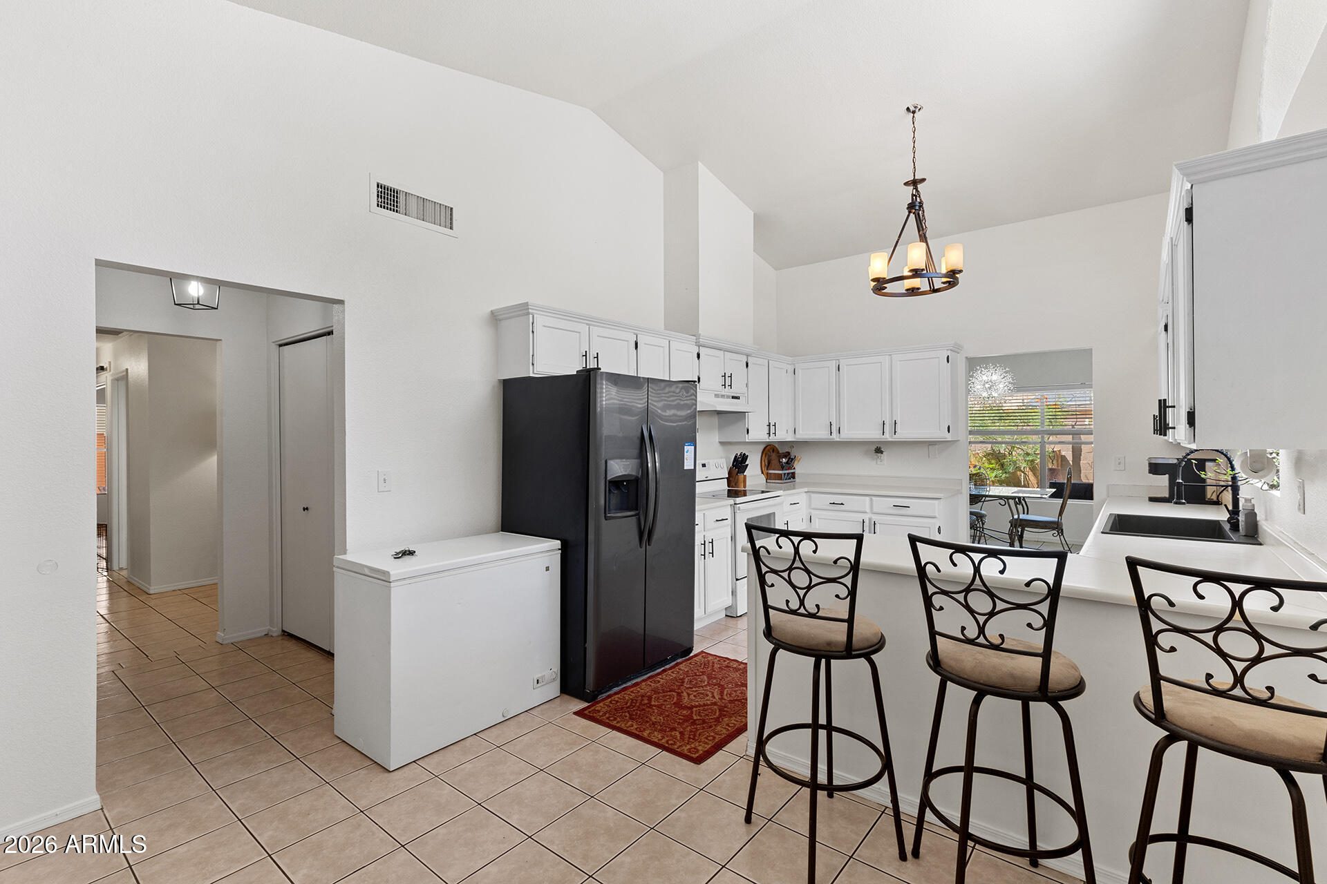 9002 West Coronado Road Phoenix, AZ 85037 - Photo 13 of 54 a kitchen with stainless steel appliances a refrigerator and a stove