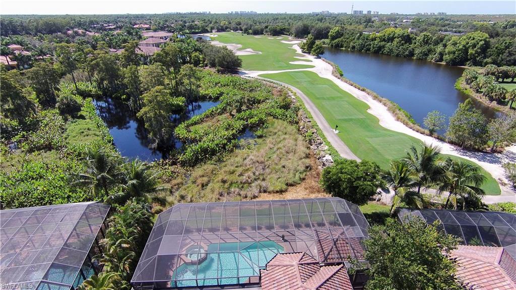 an aerial view of a house with a garden and lake view