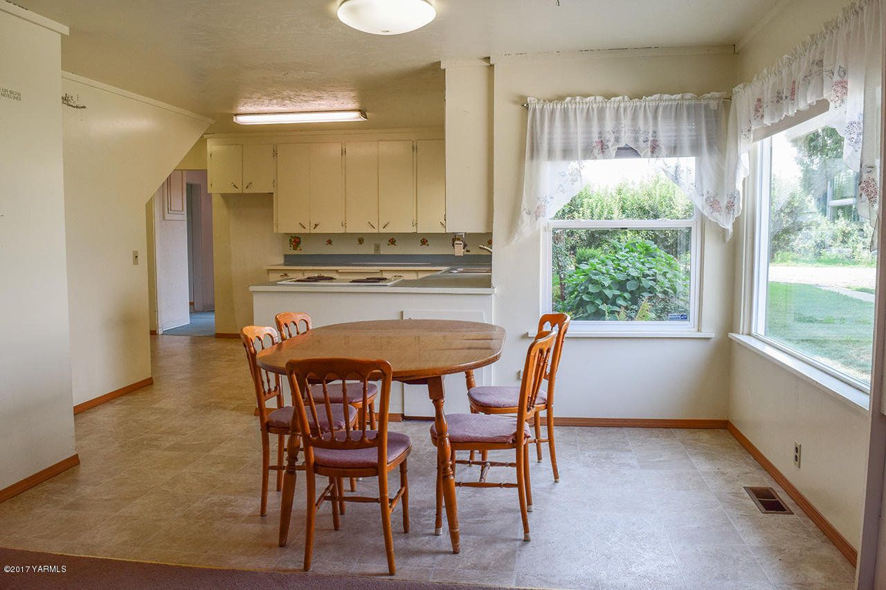 1001 Division Road Zillah, WA 98953 - Photo 7 of 24 a dining room with furniture and a window
