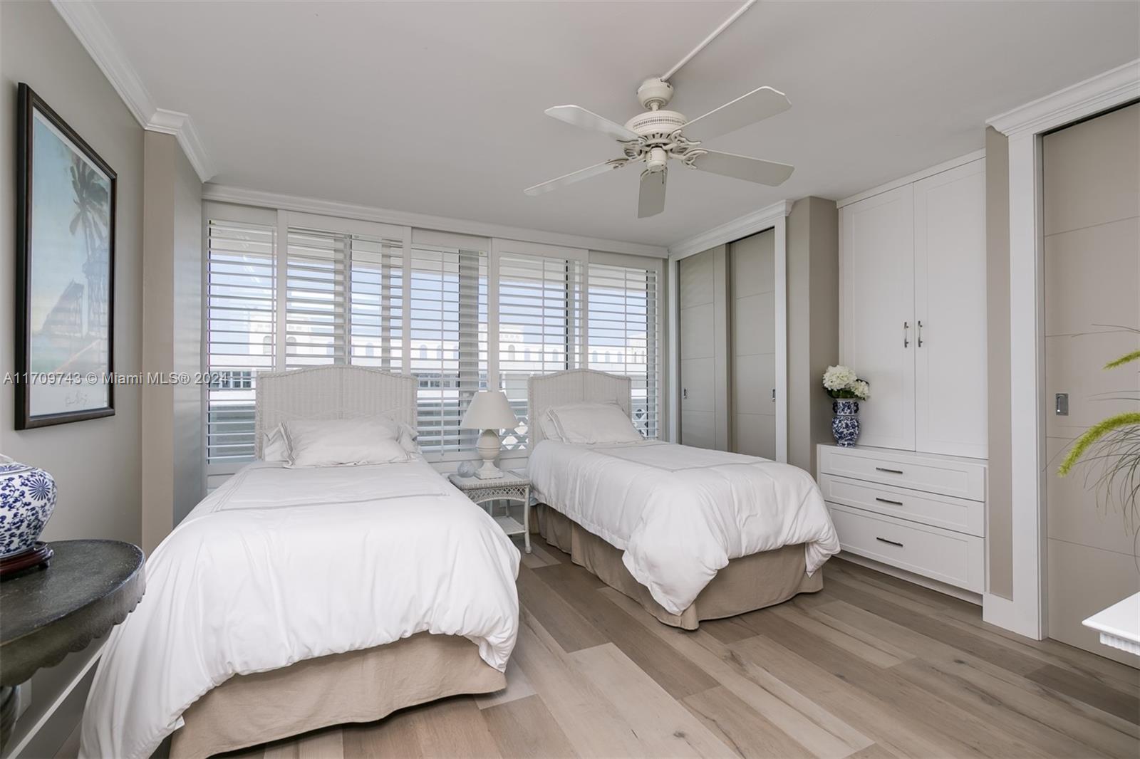 1200 South Ocean Boulevard, Unit PHF Boca Raton, FL 33432 - Photo 22 of 65 a bedroom with two beds and a chandelier