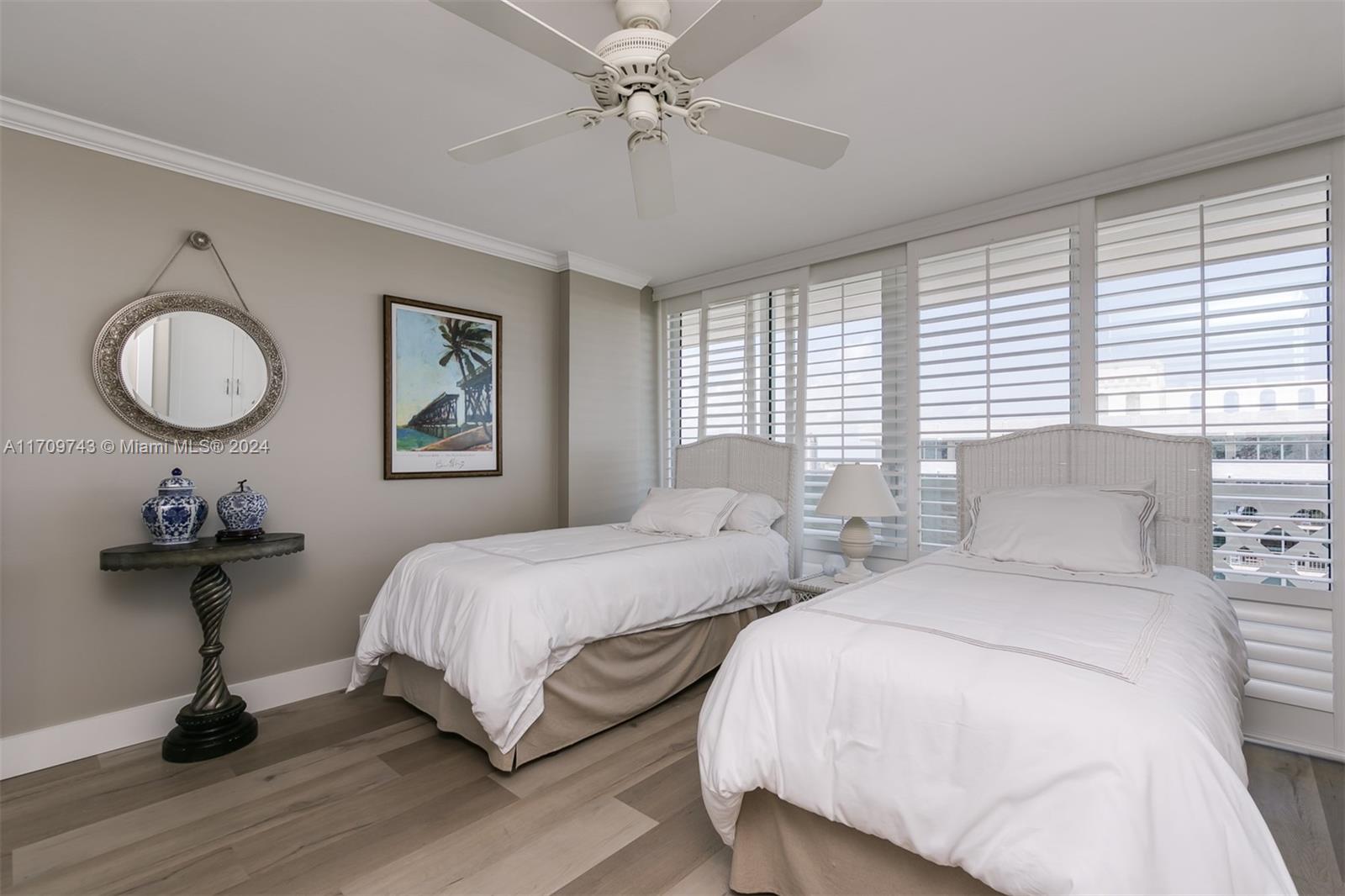 1200 South Ocean Boulevard, Unit PHF Boca Raton, FL 33432 - Photo 23 of 65 a bedroom with two beds and a chandelier