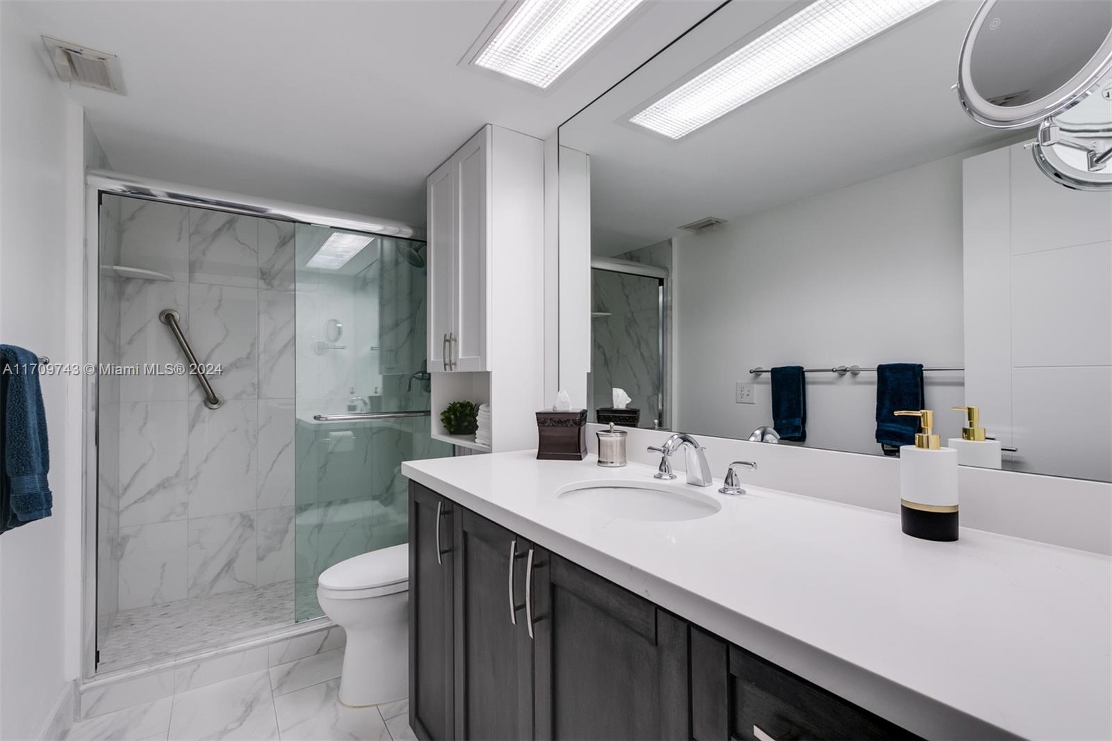 1200 South Ocean Boulevard, Unit PHF Boca Raton, FL 33432 - Photo 25 of 65 a bathroom with a sink a toilet and shower