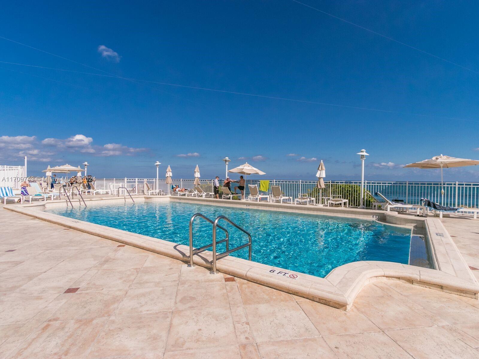 1200 South Ocean Boulevard, Unit PHF Boca Raton, FL 33432 - Photo 38 of 65 a view of swimming pool outdoor seating and city view