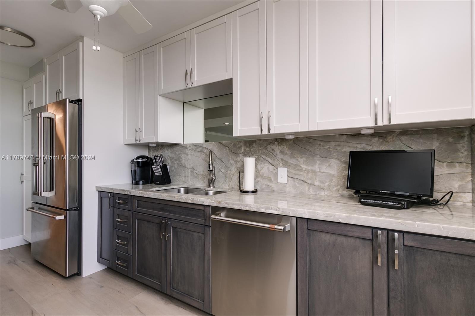 1200 South Ocean Boulevard, Unit PHF Boca Raton, FL 33432 - Photo 4 of 65 a kitchen with stainless steel appliances granite countertop a refrigerator a sink a stove a microwave and cabinets