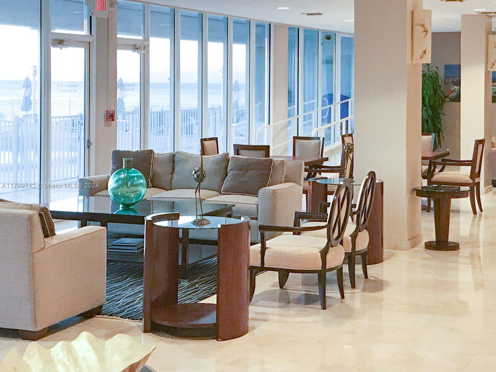 1200 South Ocean Boulevard, Unit PHF Boca Raton, FL 33432 - Photo 50 of 65 a dining room with furniture and large windows