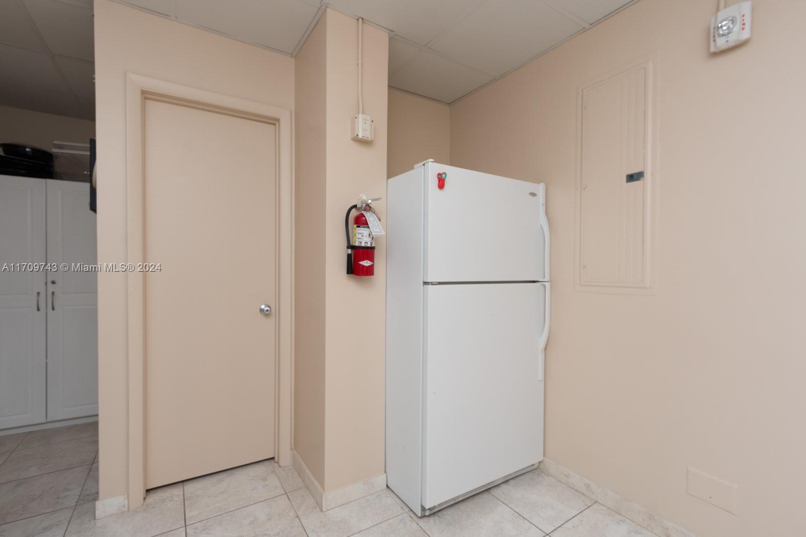 1200 South Ocean Boulevard, Unit PHF Boca Raton, FL 33432 - Photo 58 of 65 a white refrigerator freezer sitting next to a white wall