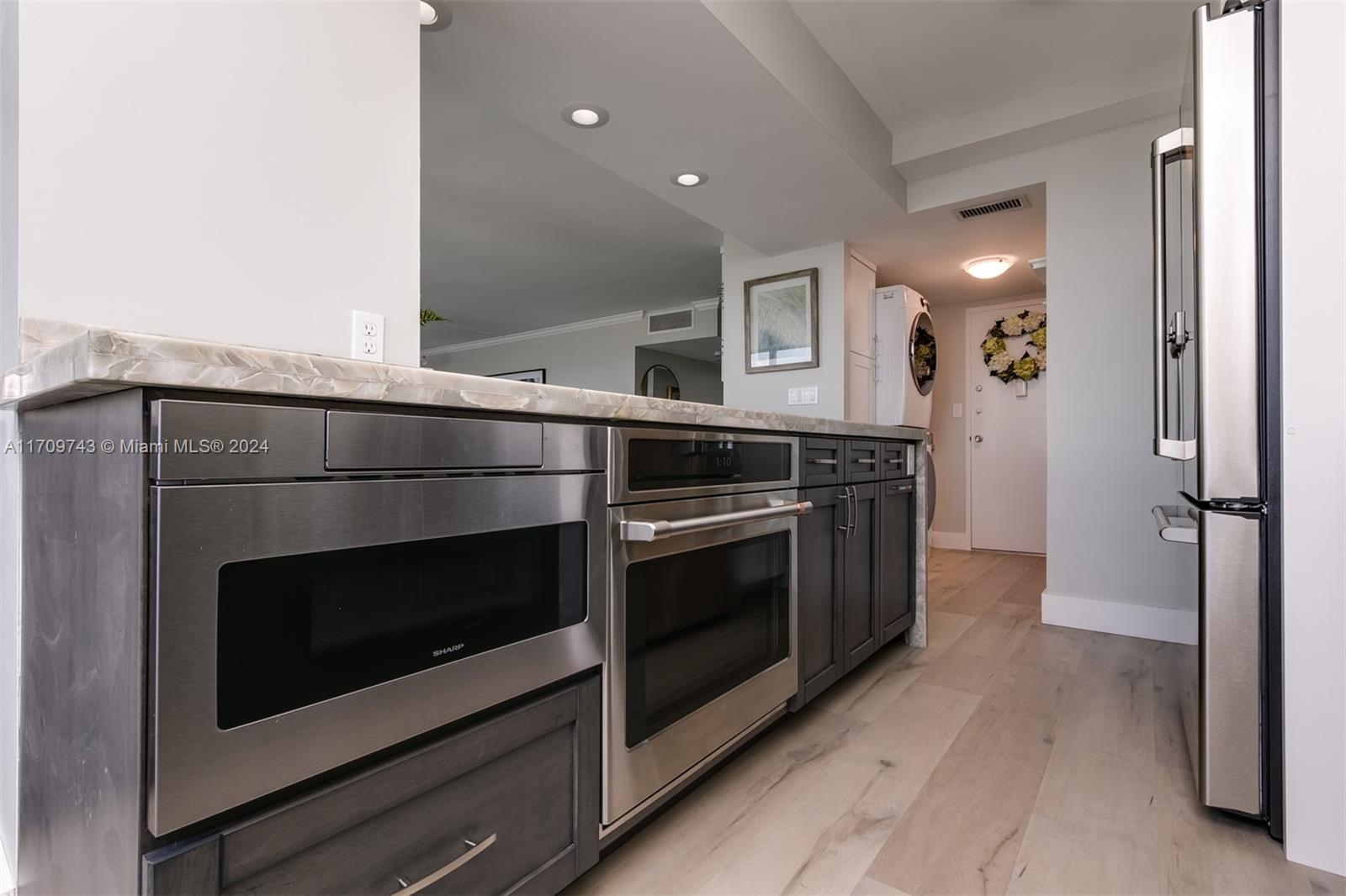 1200 South Ocean Boulevard, Unit PHF Boca Raton, FL 33432 - Photo 6 of 65 a kitchen with a stove and a microwave