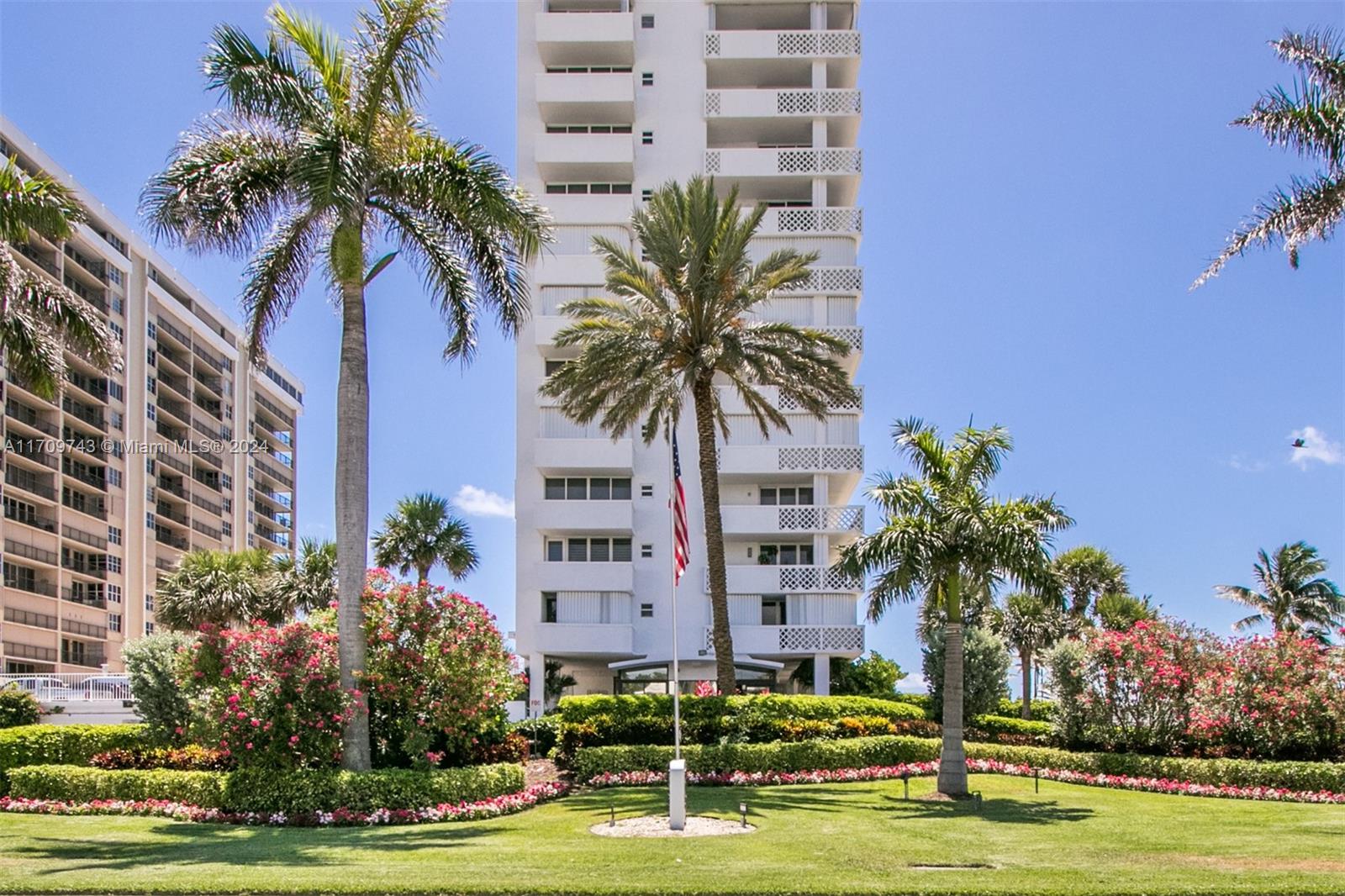 1200 South Ocean Boulevard, Unit PHF Boca Raton, FL 33432 - Photo 62 of 65 a front view of multi story residential apartment building with yard and parking space