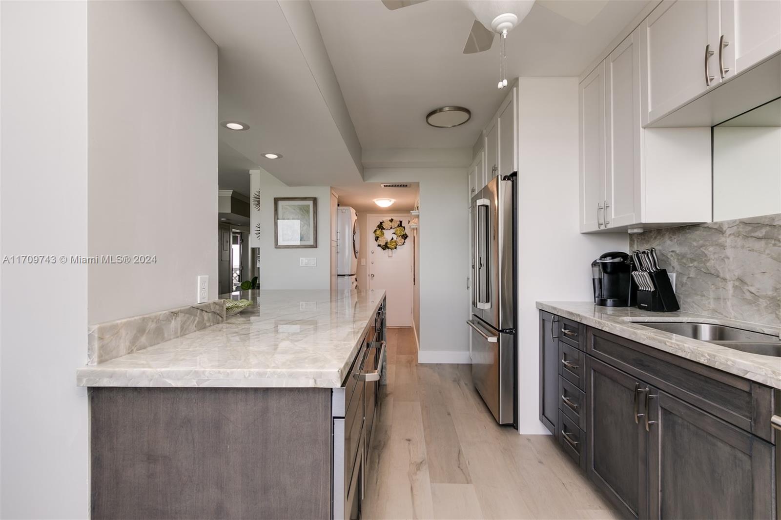 1200 South Ocean Boulevard, Unit PHF Boca Raton, FL 33432 - Photo 7 of 65 a kitchen with stainless steel appliances granite countertop a sink refrigerator and cabinets