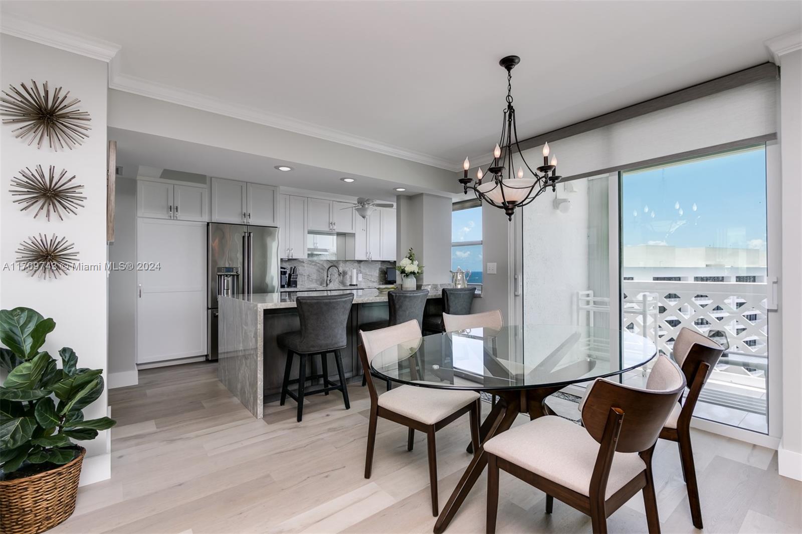 1200 South Ocean Boulevard, Unit PHF Boca Raton, FL 33432 - Photo 9 of 65 a dining room with furniture a chandelier and wooden floor