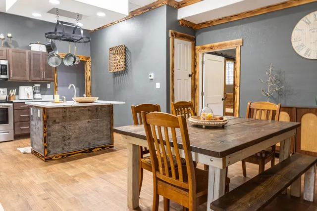 a kitchen with stainless steel appliances granite countertop a refrigerator sink and stove