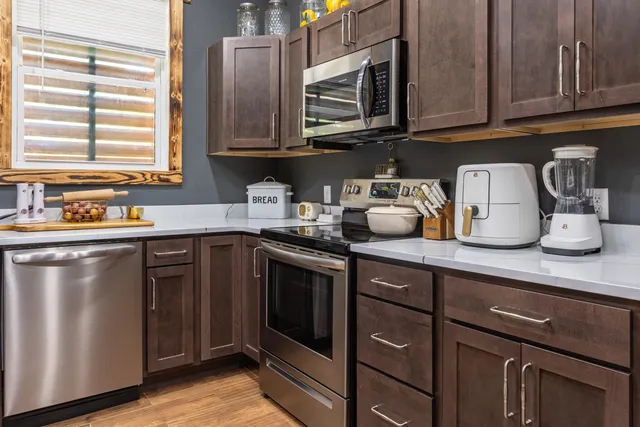 a stove top oven sitting inside of a kitchen