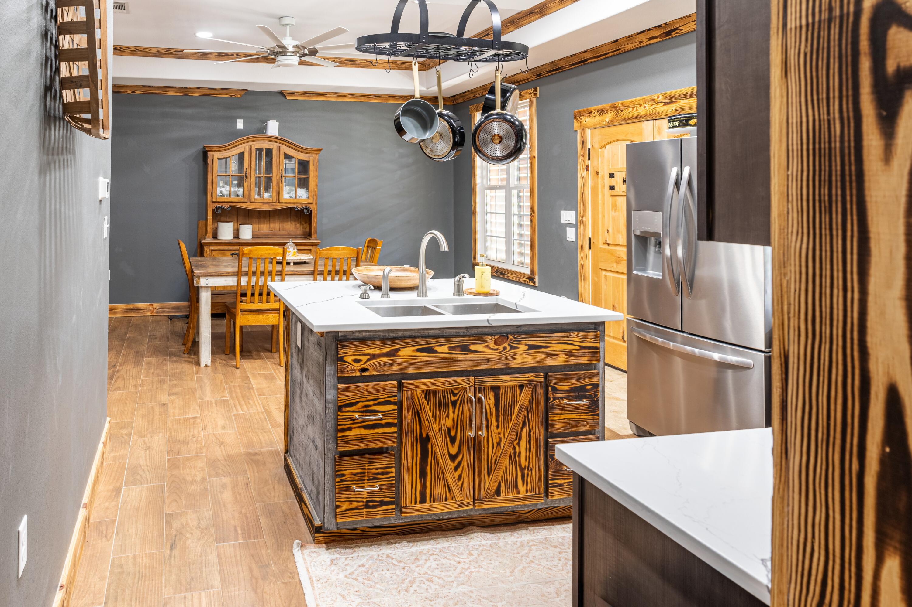 981 East Chestnut Avenue Crestview, FL 32539 - Photo 17 of 64 a kitchen with a sink a refrigerator and cabinets