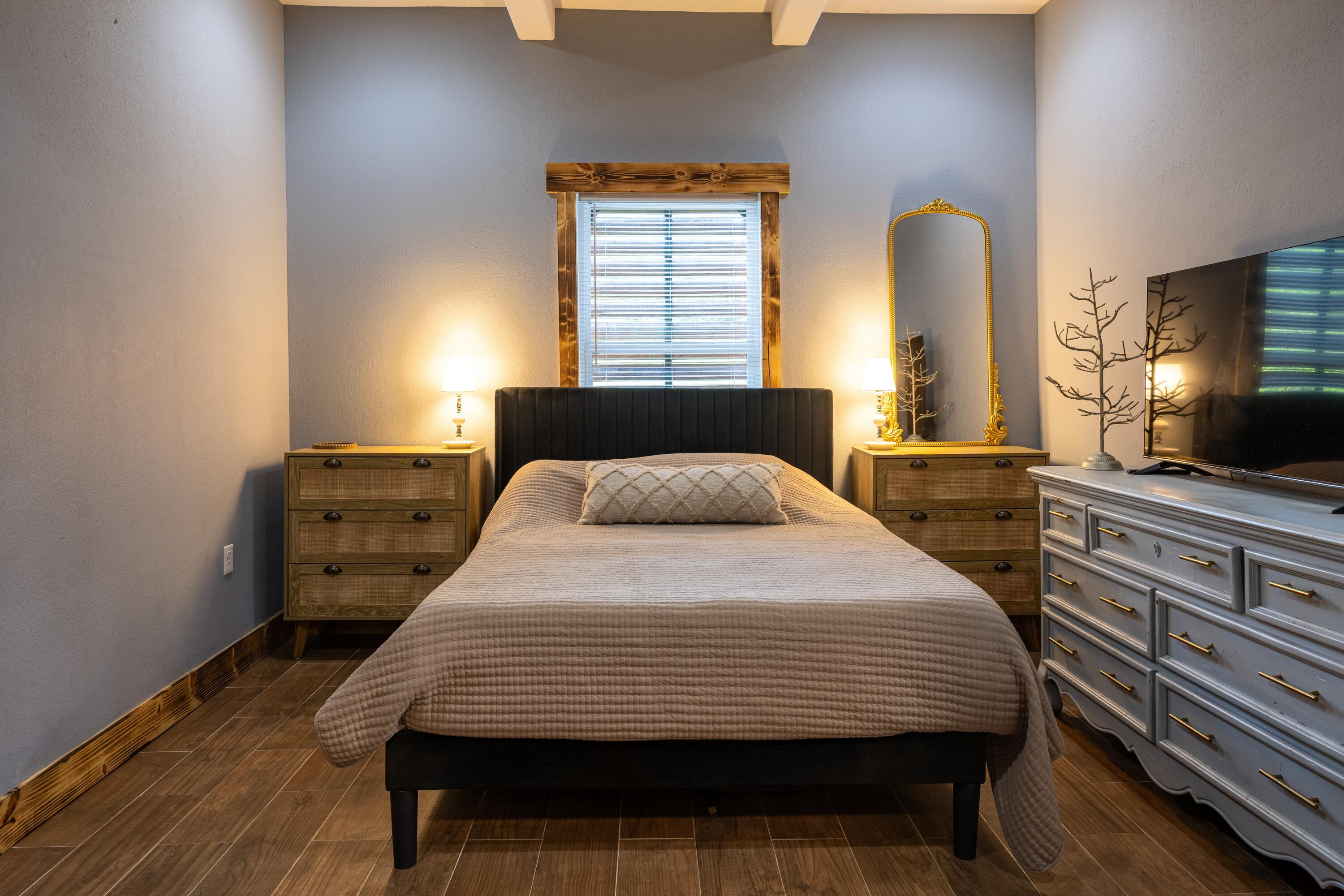 981 East Chestnut Avenue Crestview, FL 32539 - Photo 19 of 64 a bedroom with a bed and a flat tv screen on dresser