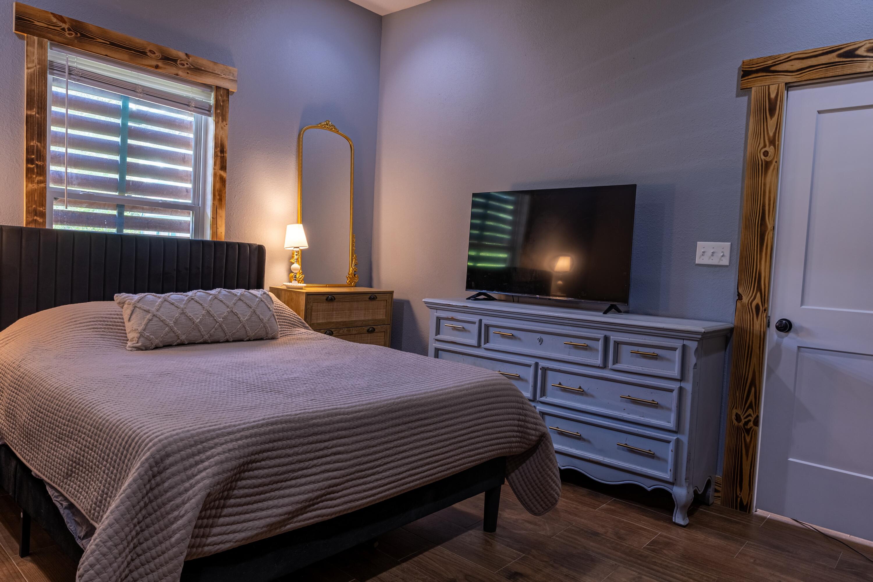 981 East Chestnut Avenue Crestview, FL 32539 - Photo 20 of 64 a bedroom with a bed and a flat screen tv