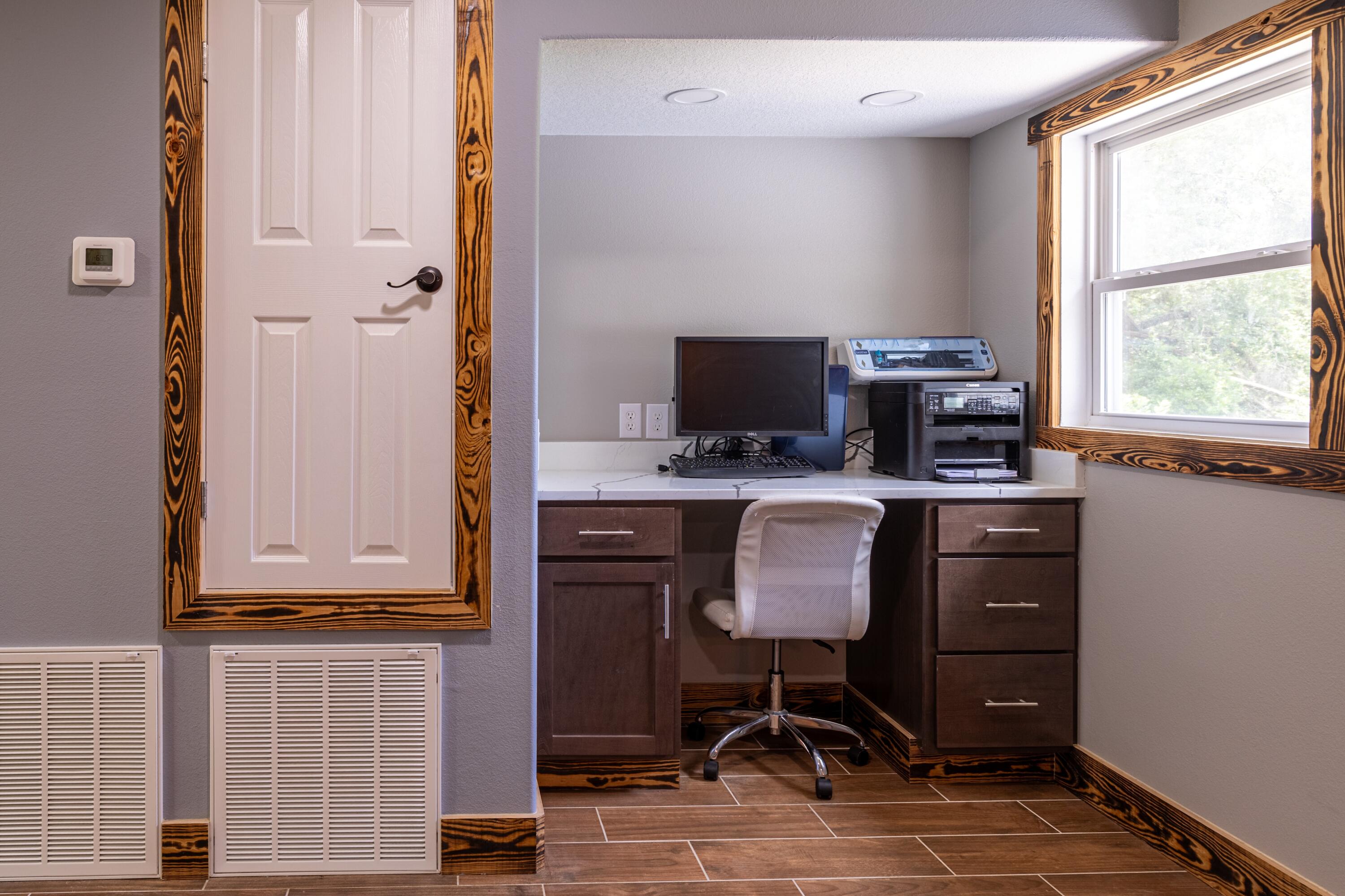 981 East Chestnut Avenue Crestview, FL 32539 - Photo 48 of 64 a view of workspace with wooden floor windows cabinet and chair