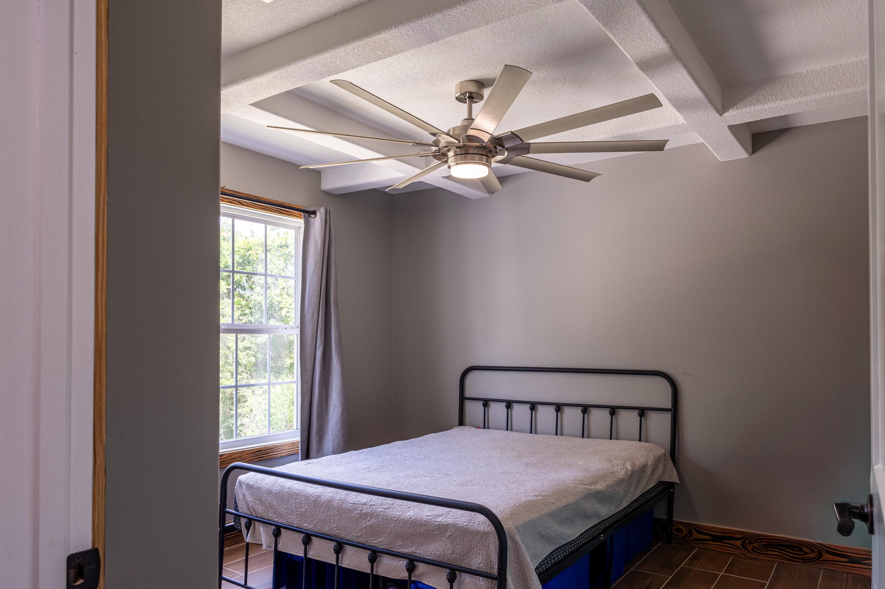 981 East Chestnut Avenue Crestview, FL 32539 - Photo 51 of 64 a bedroom with a bed and a window