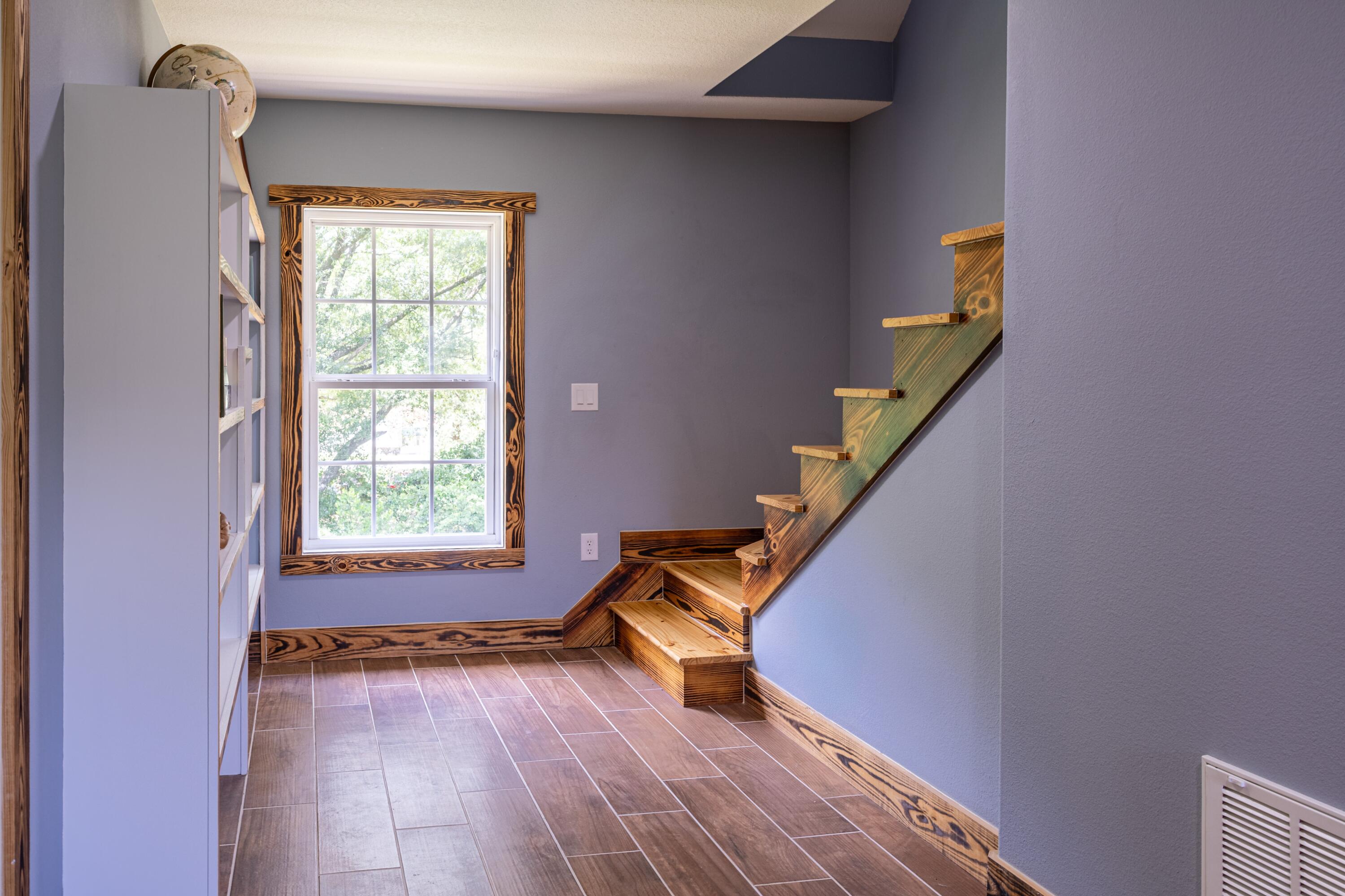 981 East Chestnut Avenue Crestview, FL 32539 - Photo 59 of 64 a view of an empty room with wooden floor and a window