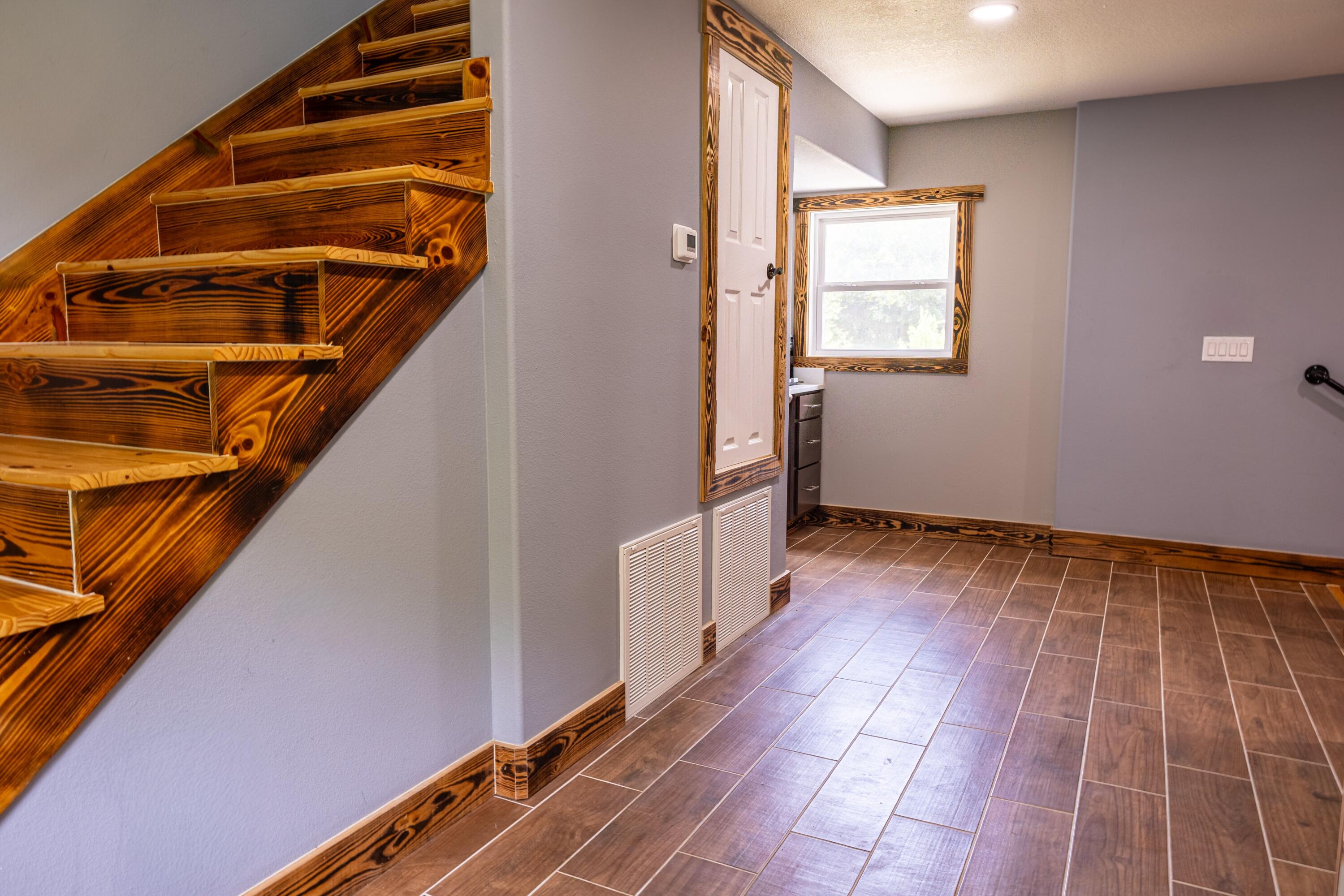 981 East Chestnut Avenue Crestview, FL 32539 - Photo 60 of 64 a view of an empty room with stairs and a window