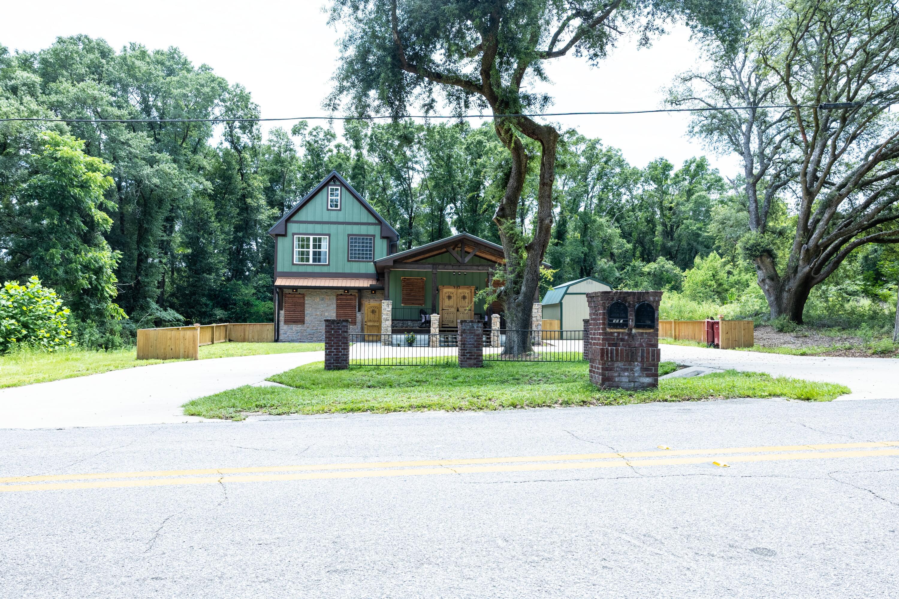 981 East Chestnut Avenue Crestview, FL 32539 - Photo 6 of 64 a front view of a house with a yard and trees