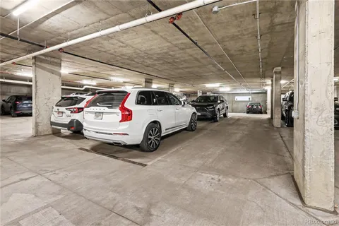 a view of parking garage with cars parked