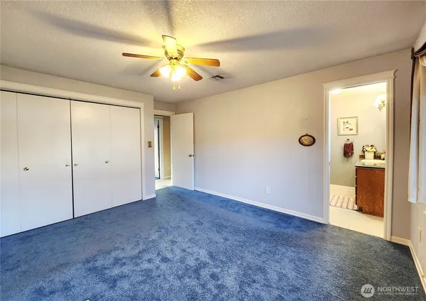 a bathroom with a granite countertop sink a mirror and shower
