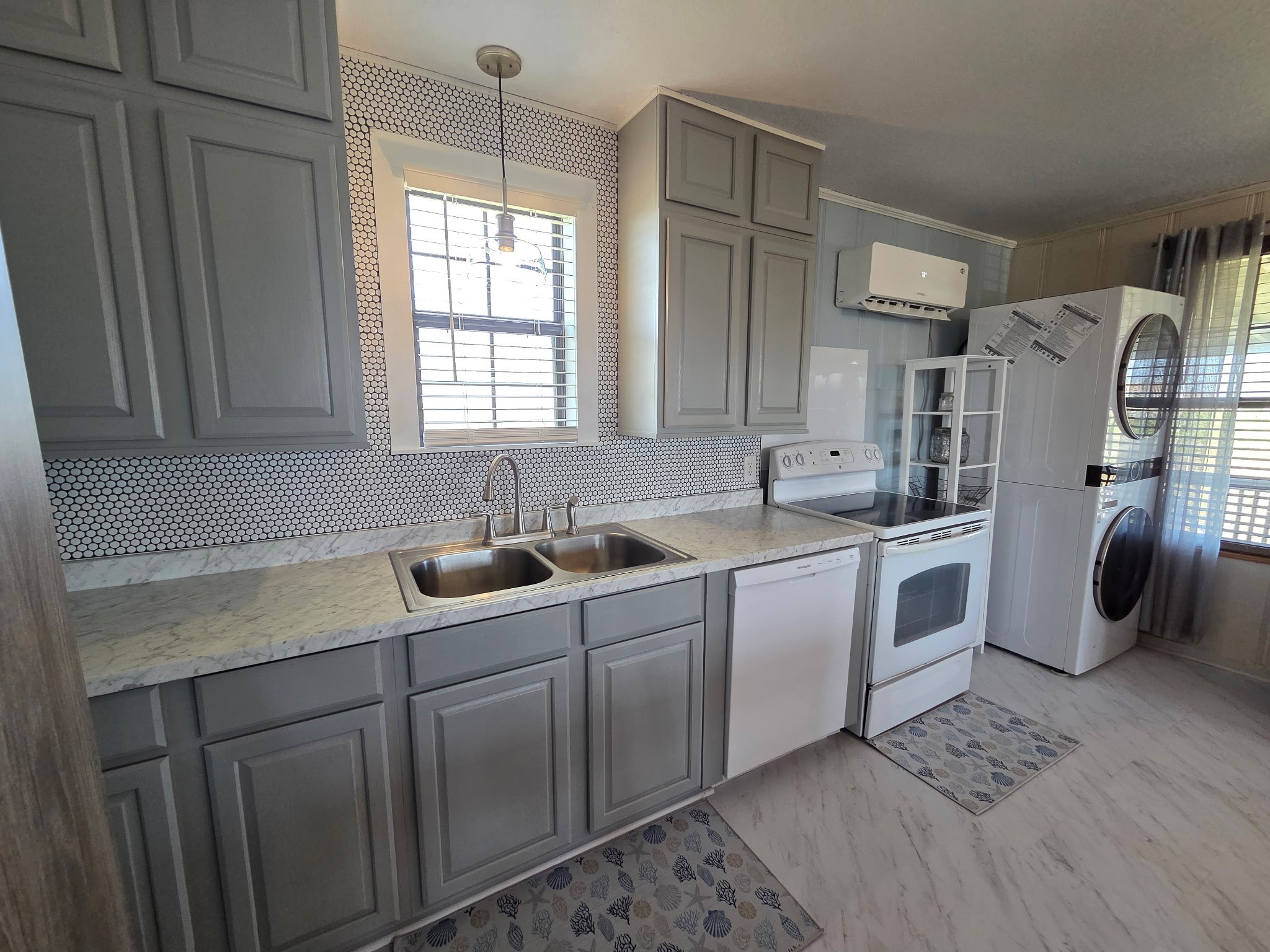 714 Caisson Street Surfside Beach, TX 77541 - Photo 5 of 12 a kitchen with white cabinets and white appliances