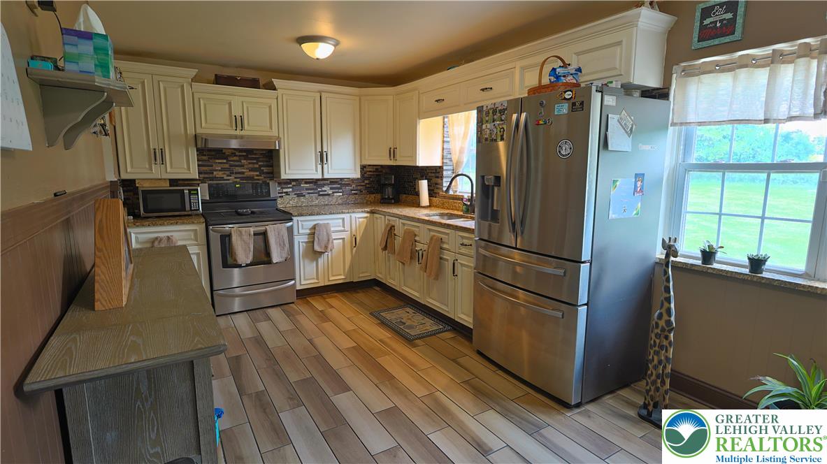 1345 Macada Road Bethlehem, PA 18017 - Photo 4 of 23 a kitchen with stainless steel appliances a refrigerator sink and microwave