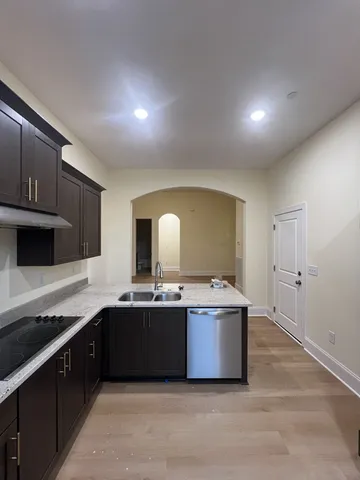 a kitchen with stainless steel appliances a sink stove and cabinets