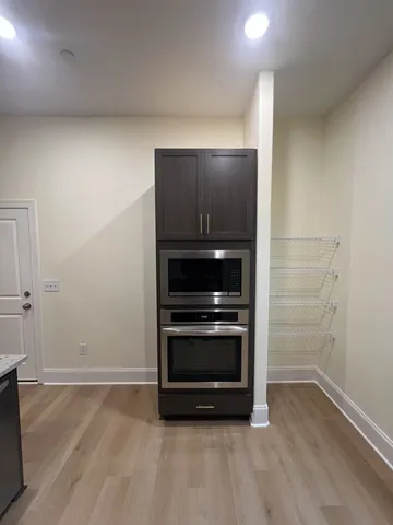 a view of an empty room and wooden floor