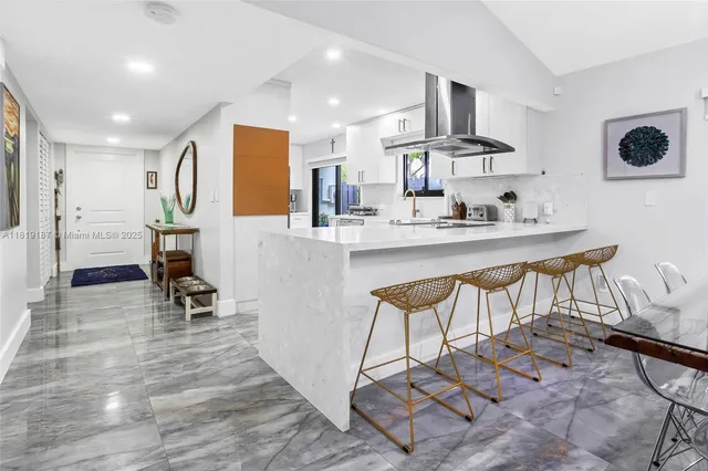 a kitchen with stainless steel appliances kitchen island granite countertop a sink and cabinets